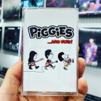 .​.​.​And Now! / PiGGiES (CASSETTE)